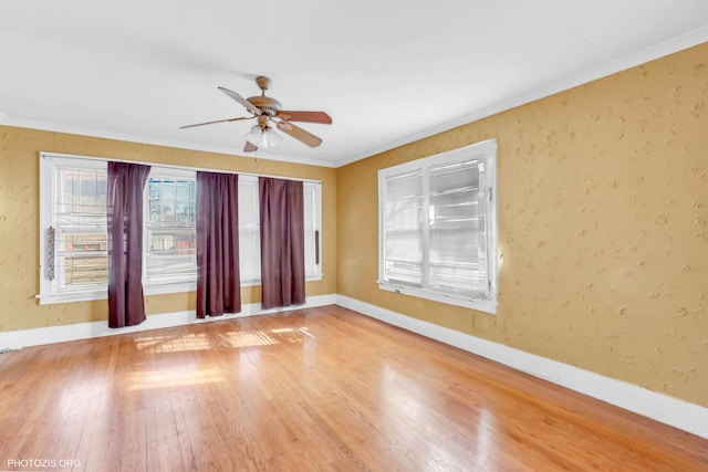 spare room with hardwood / wood-style flooring, ornamental molding, and ceiling fan