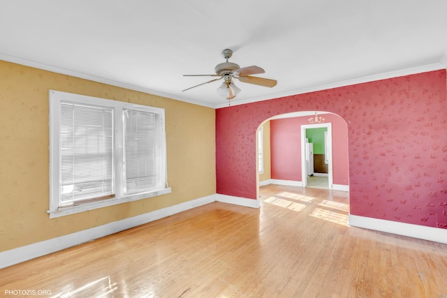 unfurnished room featuring wood-type flooring, ornamental molding, and ceiling fan