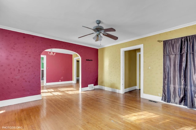 unfurnished room with hardwood / wood-style flooring, ceiling fan, and crown molding