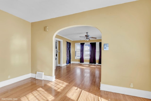 unfurnished room with ornamental molding, ceiling fan, and light hardwood / wood-style flooring