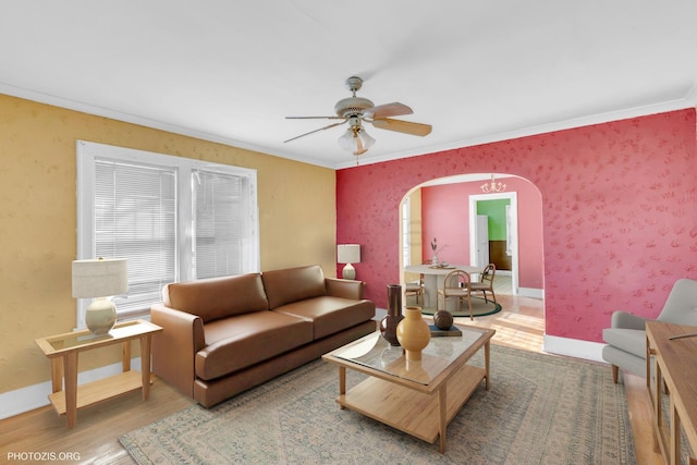 living room featuring hardwood / wood-style flooring, crown molding, and ceiling fan