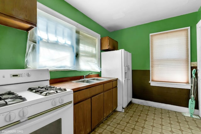 kitchen featuring white appliances and sink