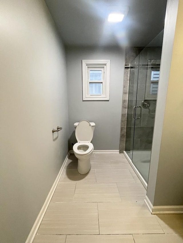 bathroom featuring toilet and an enclosed shower