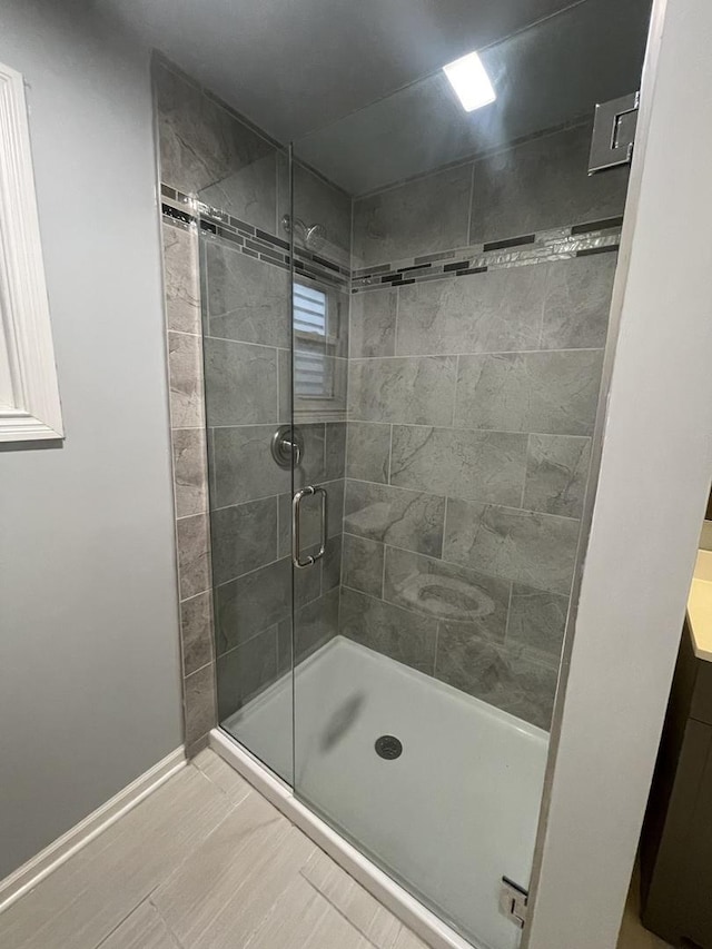 bathroom featuring a shower with shower door