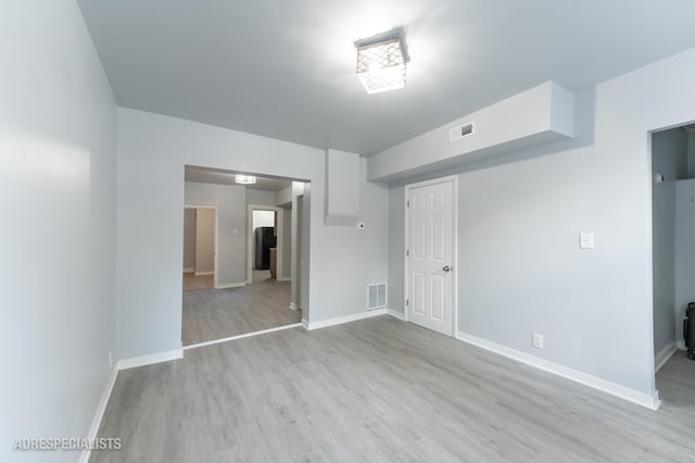 empty room with light hardwood / wood-style floors