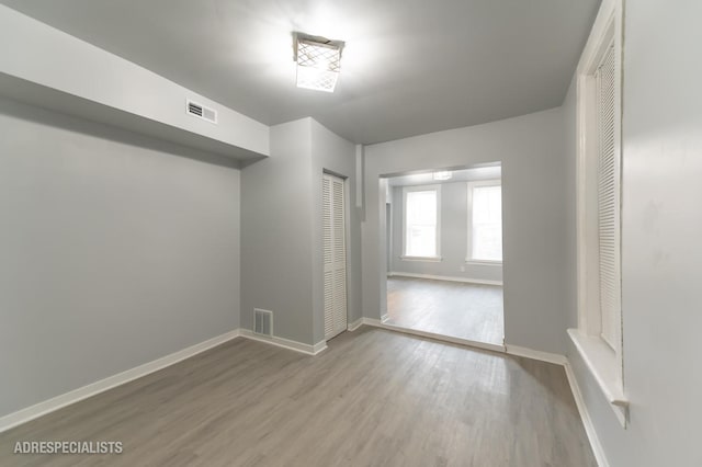 empty room with light hardwood / wood-style floors