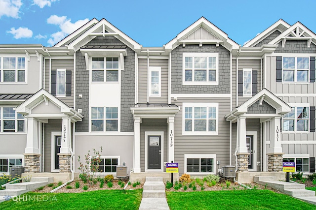 townhome / multi-family property featuring central AC unit and a front lawn