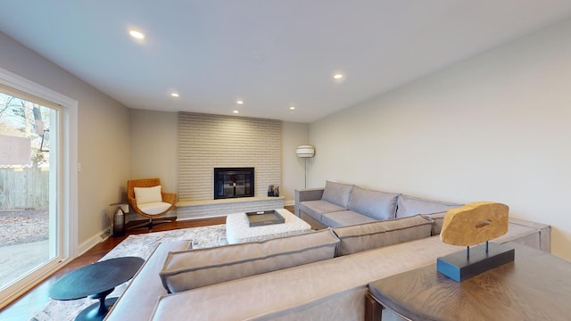 living room with hardwood / wood-style floors and a fireplace