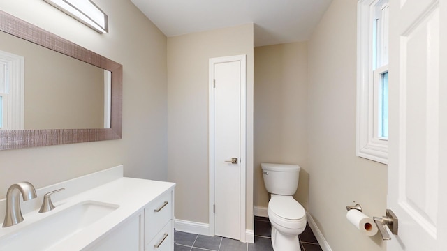 bathroom featuring vanity, tile patterned floors, and toilet