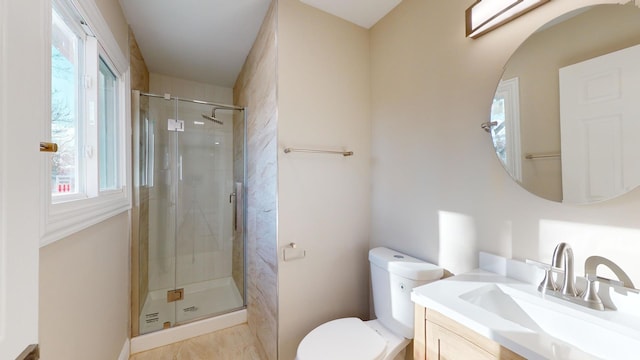 bathroom with vanity, a shower with shower door, and toilet