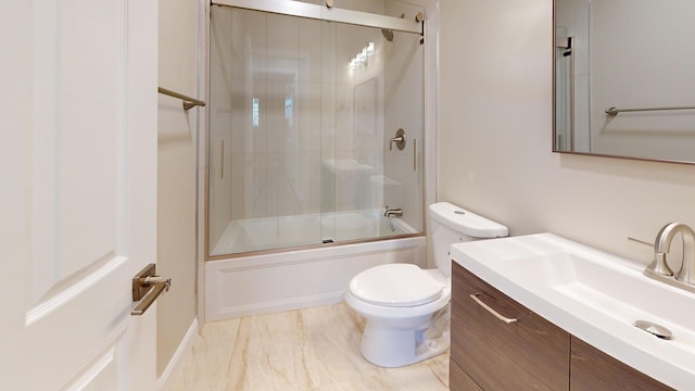 full bathroom with vanity, bath / shower combo with glass door, and toilet