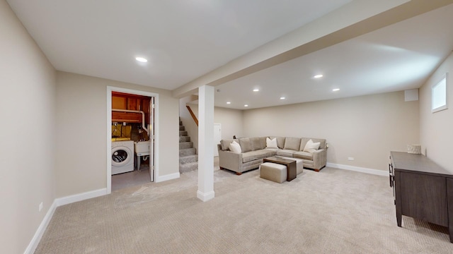 living room with washer / clothes dryer and light carpet