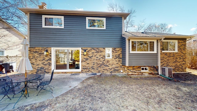 rear view of property featuring a patio area and central air condition unit