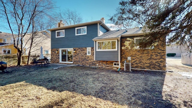 rear view of house with a yard