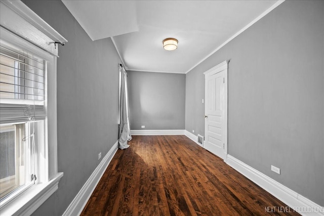 interior space with ornamental molding and dark hardwood / wood-style floors