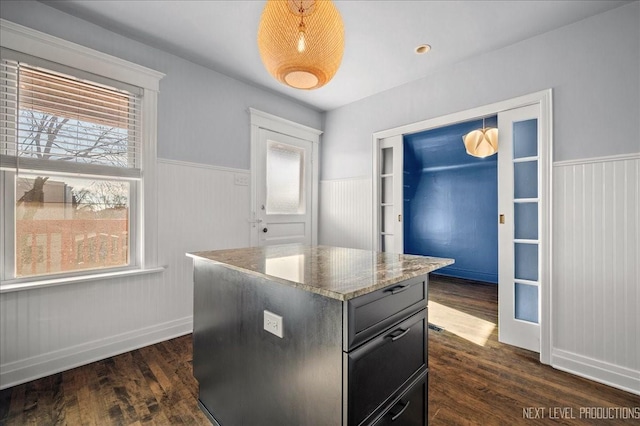 kitchen featuring plenty of natural light, dark hardwood / wood-style flooring, and a kitchen island