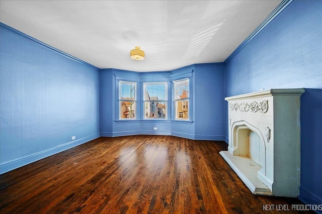 unfurnished living room with crown molding and dark hardwood / wood-style floors