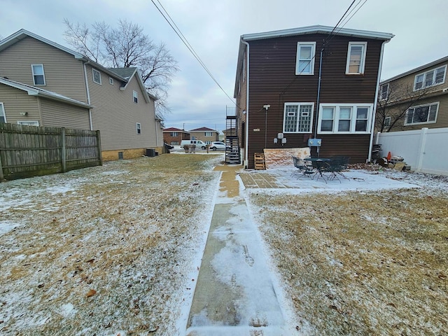 view of snow covered rear of property