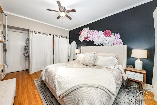 bedroom with crown molding, ceiling fan, and light wood-type flooring