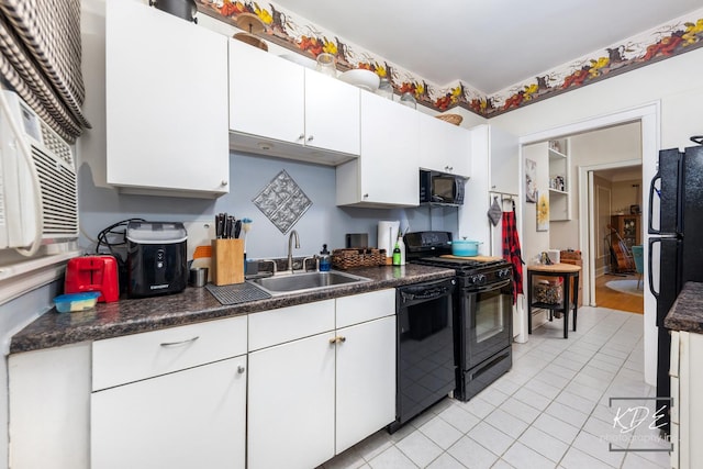 kitchen featuring white cabinetry, sink, light tile patterned floors, and black appliances