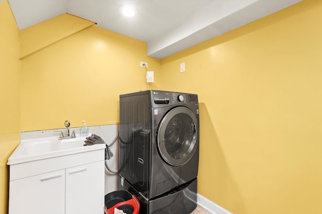 washroom featuring cabinets, washer / clothes dryer, and sink