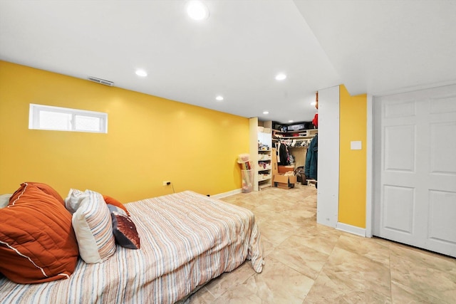 bedroom with a walk in closet and a closet