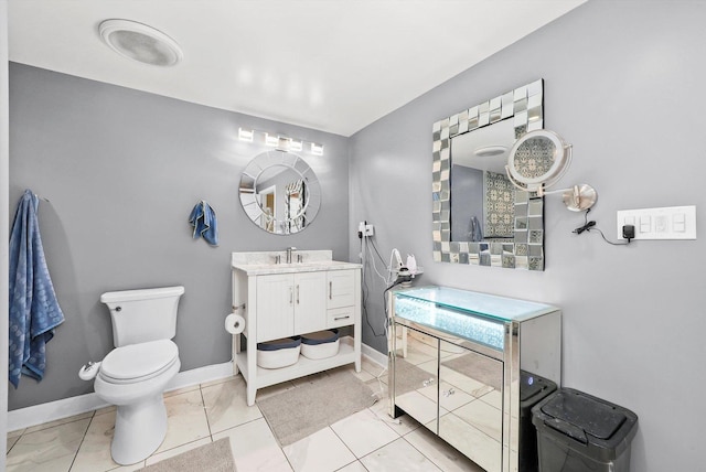 bathroom featuring vanity, tile patterned flooring, and toilet