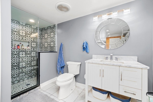 bathroom with tiled shower, vanity, and toilet