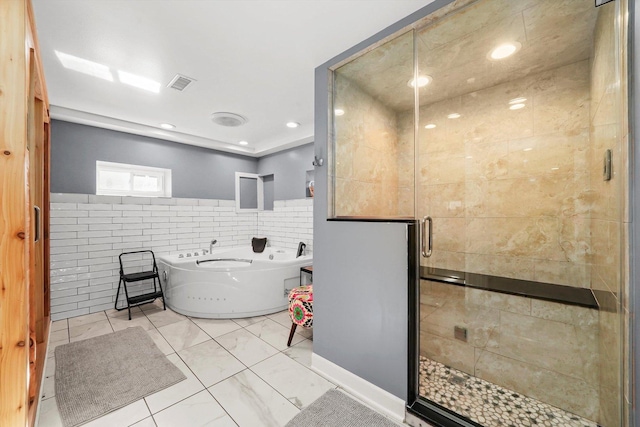 bathroom featuring separate shower and tub and tile walls