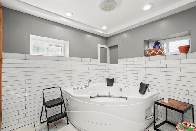 bathroom featuring a bathing tub and tile walls