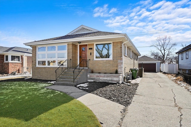 view of front of home with a garage, an outbuilding, and a front lawn