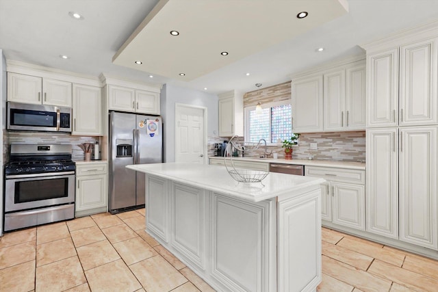 kitchen with white cabinetry, appliances with stainless steel finishes, and a center island