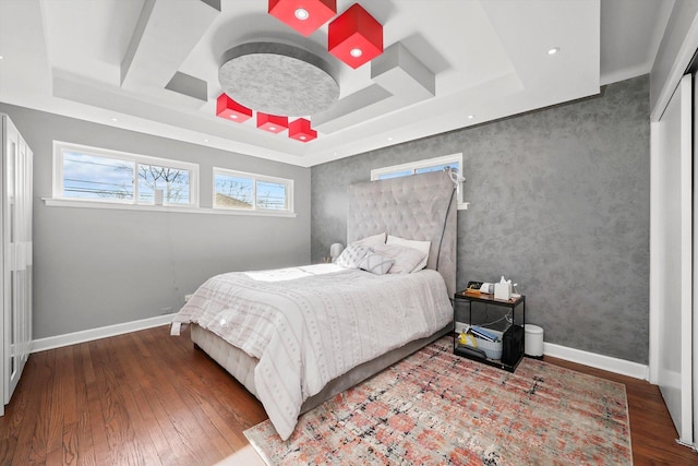 bedroom featuring hardwood / wood-style flooring, coffered ceiling, and beamed ceiling