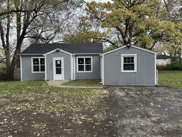 exterior space featuring a front lawn and fence