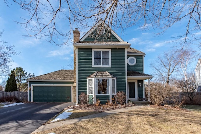 view of front property featuring a garage and a front yard