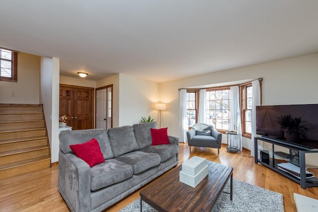 living room with a wealth of natural light and light wood-type flooring