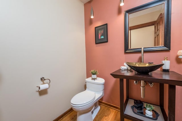 bathroom featuring sink, hardwood / wood-style flooring, and toilet