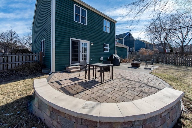 back of property featuring an outdoor fire pit and a patio area