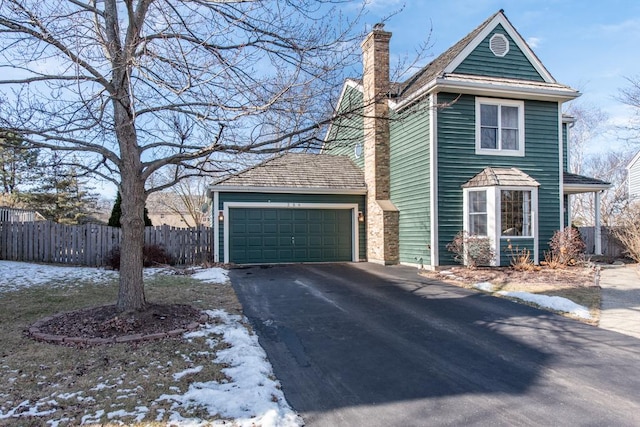 view of snowy exterior with a garage