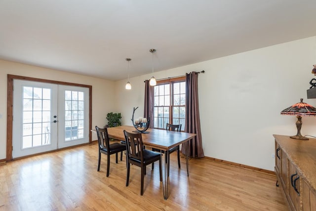 dining area with french doors and light wood-type flooring