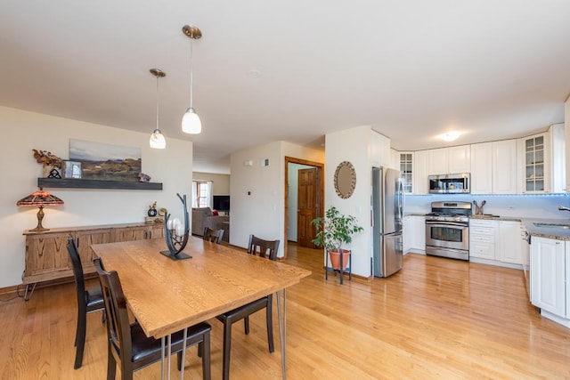 dining room featuring sink and light wood-type flooring