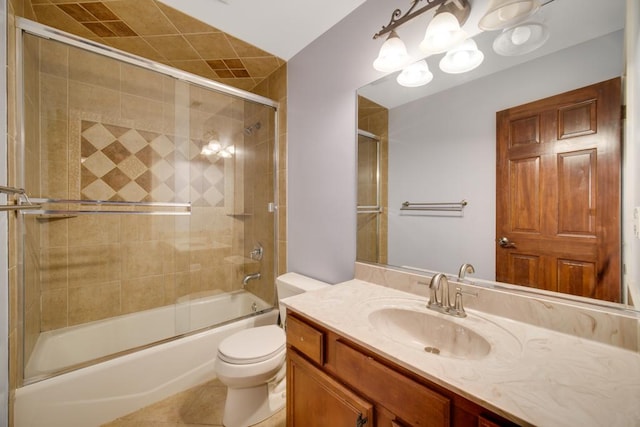 full bathroom featuring tile patterned flooring, enclosed tub / shower combo, vanity, and toilet