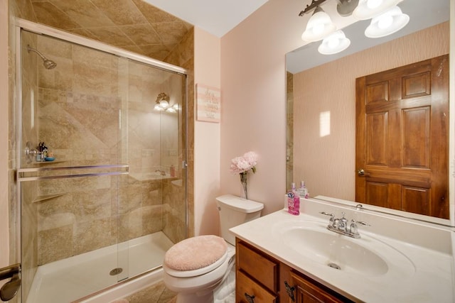 bathroom featuring walk in shower, vanity, and toilet