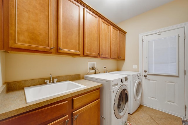 laundry room featuring cabinets, separate washer and dryer, sink, and light tile patterned floors