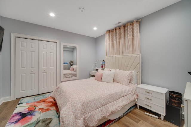 bedroom featuring light hardwood / wood-style floors and a closet