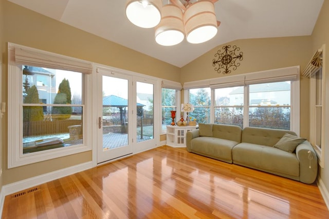 unfurnished sunroom featuring vaulted ceiling