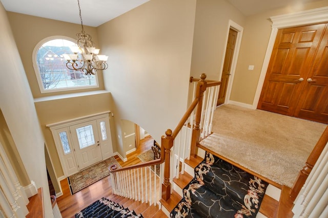 foyer entrance featuring hardwood / wood-style flooring and a notable chandelier