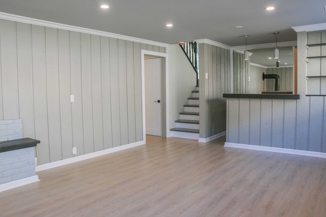 unfurnished living room with recessed lighting, stairs, crown molding, and wood finished floors