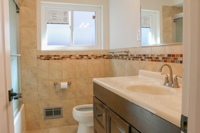 bathroom featuring an enclosed shower, visible vents, toilet, tile walls, and vanity