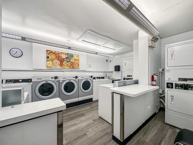 washroom with dark wood-type flooring, washing machine and dryer, and stacked washer and clothes dryer